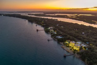 Luxury beachfront villas at Playa de Coco in Belize at sunset.