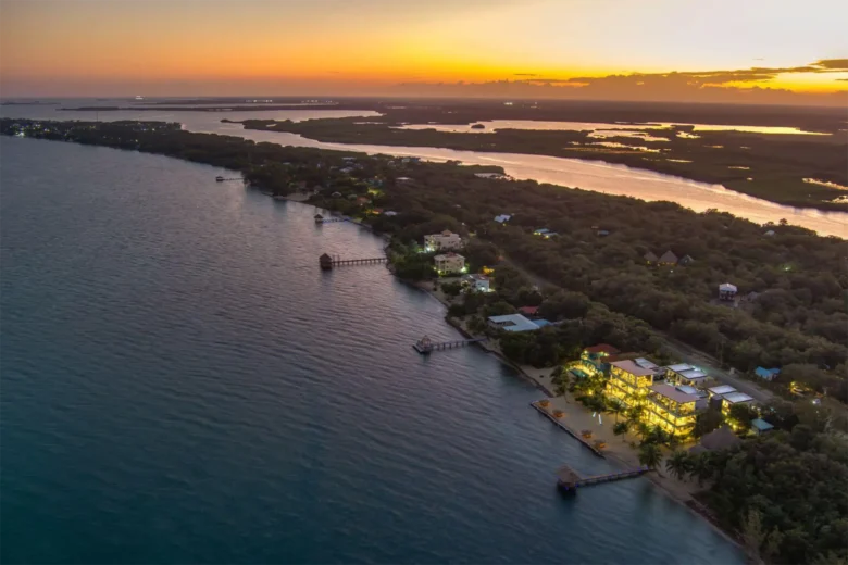 Luxury beachfront villas at Playa de Coco in Belize at sunset.