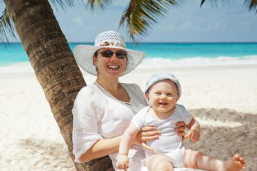 A happy mother and child enjoying a luxury Mother's Day getaway at a tropical beach resort in Belize.